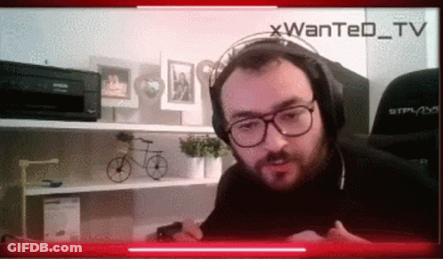 Man With Headphones And Glasses On Wanted TV Screen GIF