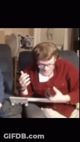 Man With Headphones And Glasses Sitting On Couch With Laptop GIF