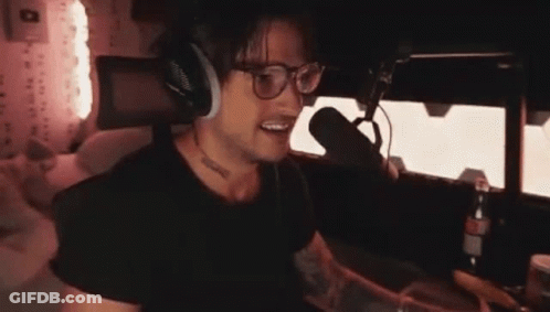 Man With Headphones And Glasses Talking Into Microphone GIF