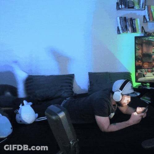 Man With Headphones And Hat Lying On Couch GIF
