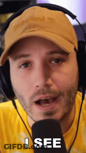 Man With Headphones And Hat Saying I See At Microphone GIF