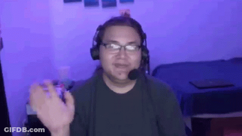 Man With Headphones And Microphone Sitting In Front Of Bed GIF