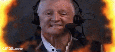 Man With Headphones And Microphone Surrounded By Flames GIF