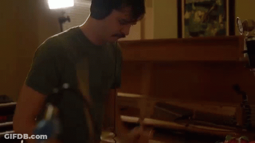 Man With Headphones And Mustache Playing Piano GIF