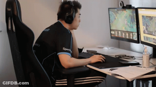 Man With Headphones And Specs Shirt At Two Monitors GIF
