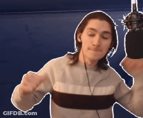 Man With Headphones And Sweater Holding Microphone GIF