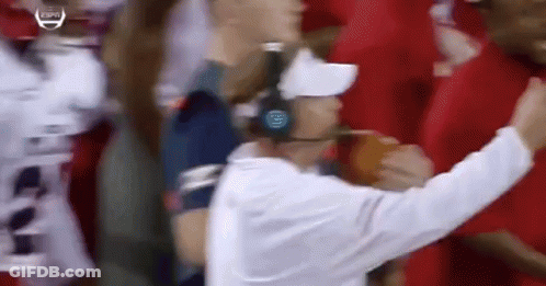 Man With Headphones And White Hat In Front Of Crowd GIF