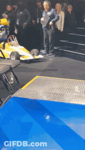 Man With Headphones And Yellow Race Car GIF