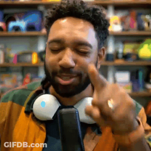 Man With Headphones Around Neck Pointing GIF