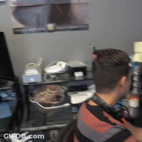 Man With Headphones At Computer Desk GIF