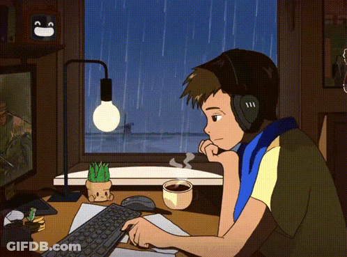 Man With Headphones At Desk With Computer And Coffee GIF