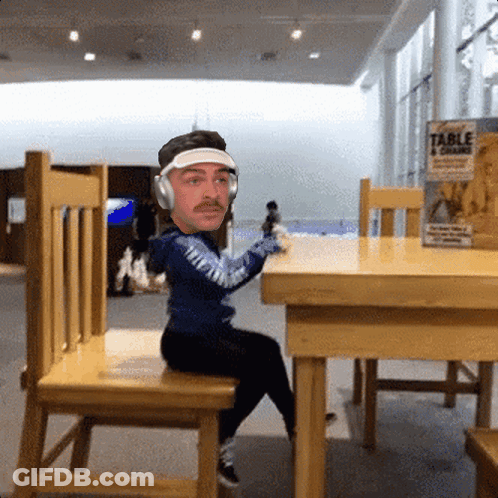Man With Headphones At Table With Table 4 Grains Can GIF