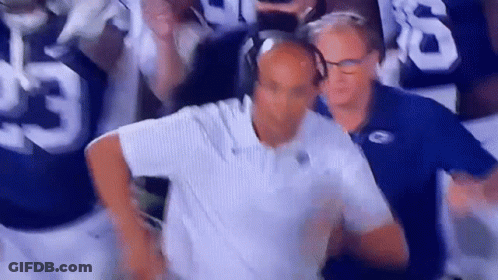 Man With Headphones Before Football Players GIF