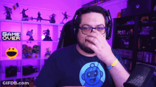 Man With Headphones Covering Nose In Front Of Game Over Sign GIF