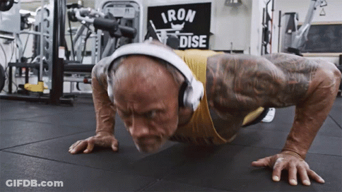 Man With Headphones Doing Push Ups Iron Dise Sign GIF
