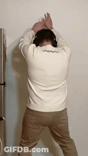 Man With Headphones Head Against Wall GIF