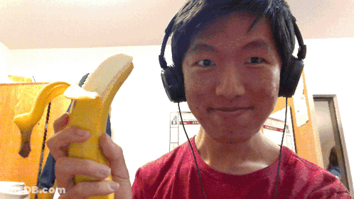 Man With Headphones Holding Banana And Smiling GIF