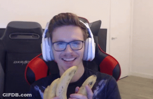 Man With Headphones Holding Bananas In Front Of DXRacer Chair GIF
