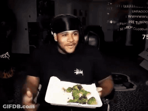 Man With Headphones Holding Plate Of Broccoli GIF