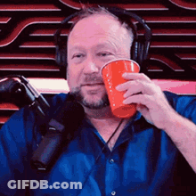 Man With Headphones Holding Red Cup GIF