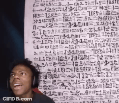 Man With Headphones In Front Of Ancient Writing Wall GIF