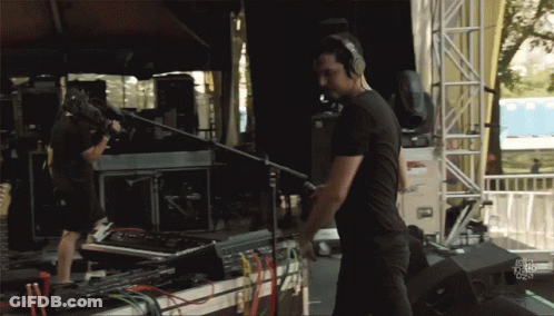 Man With Headphones In Front Of Fox News Sign GIF