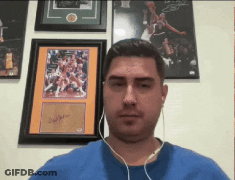Man With Headphones In Front Of Framed Basketball Picture Signed By Brad Jackson GIF