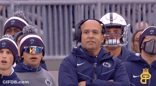 Man With Headphones In Front Of Penn State Hats GIF