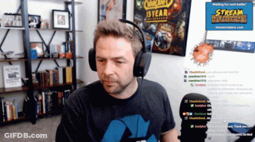 Man With Headphones In Front Of Stream Raider Sign GIF