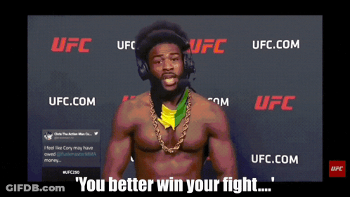 Man With Headphones In Front Of UFC Sign GIF