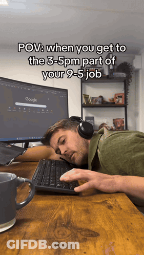 Man With Headphones Laying At Desk With Google Monitor GIF