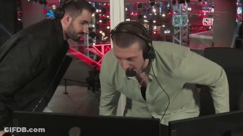 Man With Headphones Looking At Another Man At Computer GIF