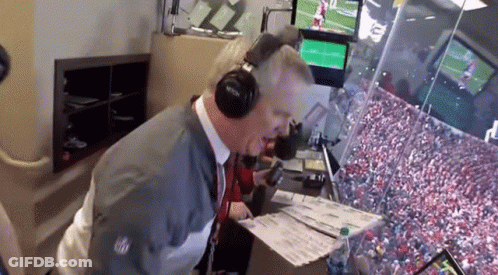 Man With Headphones Looking At Papers In Stadium GIF