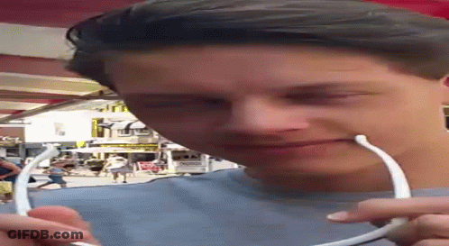 Man With Headphones Looking Down At McDonald's Sign GIF