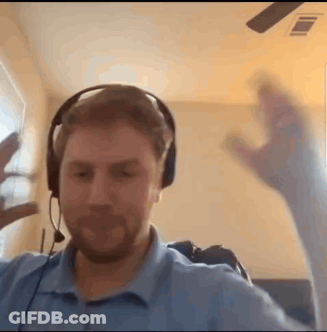 Man With Headphones Making Funny Face At Window GIF