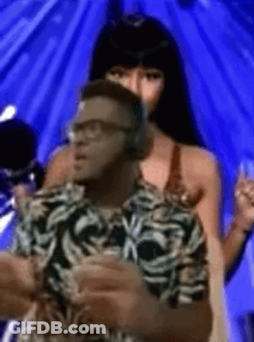Man With Headphones Next To Woman In Bikini GIF