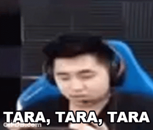 Man With Headphones Playing Game On Phone In Blue Chair GIF
