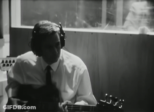 Man With Headphones Playing Guitar In Dark Room GIF