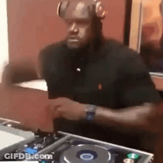 Man With Headphones Playing Turntable In Dark Room GIF