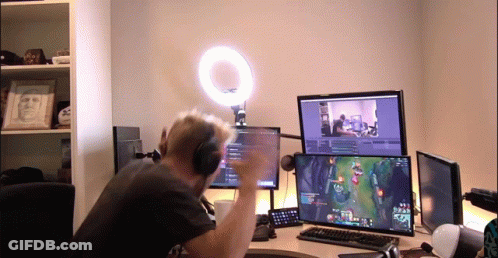 Man With Headphones Playing Video Game On Two Monitors GIF