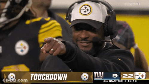 Man With Headphones Pointing At Touchdown Screen GIF