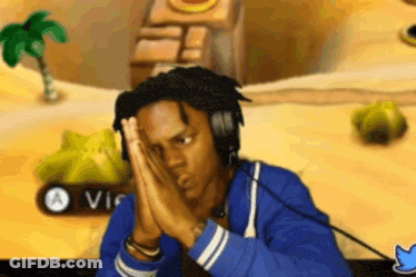 Man With Headphones Sitting At Video Game Hands On Face GIF