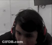 Man With Headphones Sitting In Front Of TV GIF