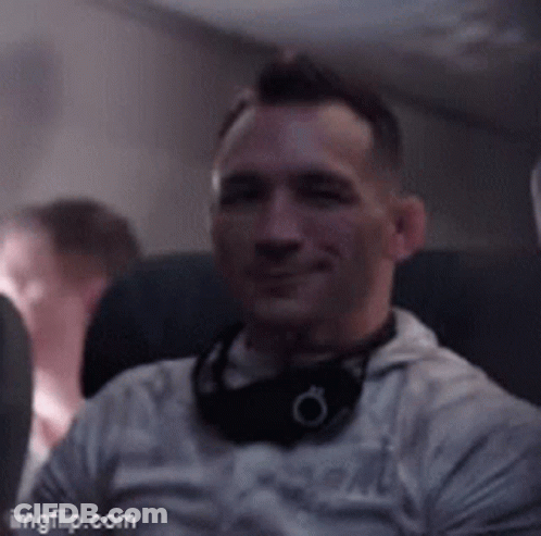 Man With Headphones Sitting On Airplane GIF