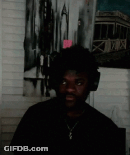 Man With Headphones Standing In Front Of Painting GIF