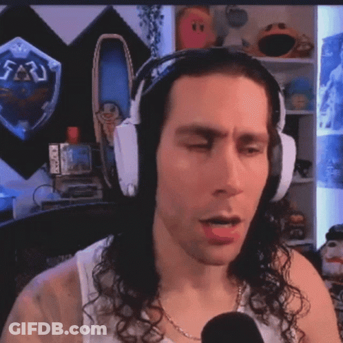 Man With Headphones Talking Into Microphone In Front Of Zelda Shield GIF