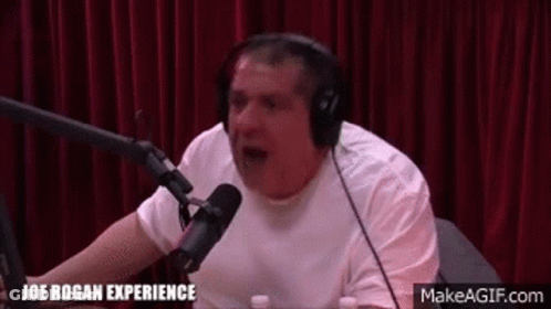 Man With Headphones Talking Into Microphone In Studio GIF