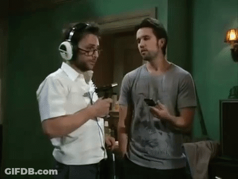Man With Headphones Talking To Man With Cell Phone GIF