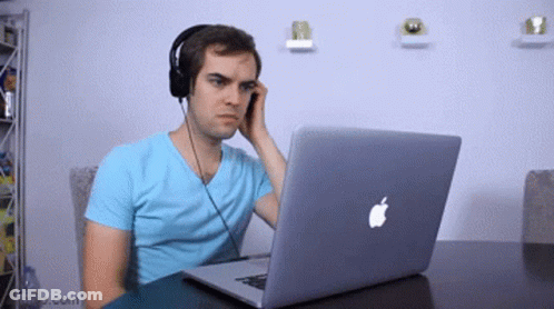 Man With Headphones Using Apple Laptop GIF