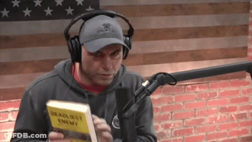 Man With Headphones Vortex Hat Holding Deadliest Enemy Book GIF